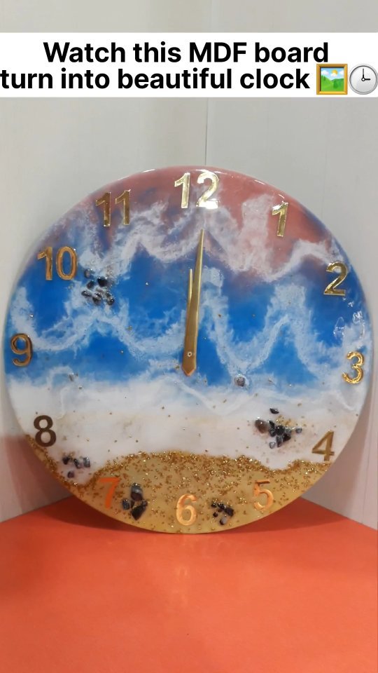 Round blue, white, and gold resin clock with gold numerals